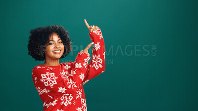 Buy stock photo Christmas, pointing and portrait with woman in studio for holiday season, celebration and promotion. Festive deals, xmas event and announcement with person on green background space with mockup