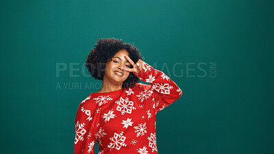Buy stock photo Dance, peace sign and Christmas with portrait of woman in studio for holiday season, celebration and party. Festive vacation, xmas event and happiness with person on green background space for cheer