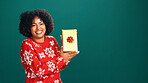 Present, portrait and black woman in studio for christmas with tradition, prize or giveaway. Excited, mockup space and African female person with xmas gift box for festive season by green background.