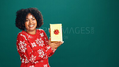 Buy stock photo Present, portrait and black woman in studio for christmas with tradition, prize or giveaway. Excited, mockup space and African female person with xmas gift box for festive season by green background.