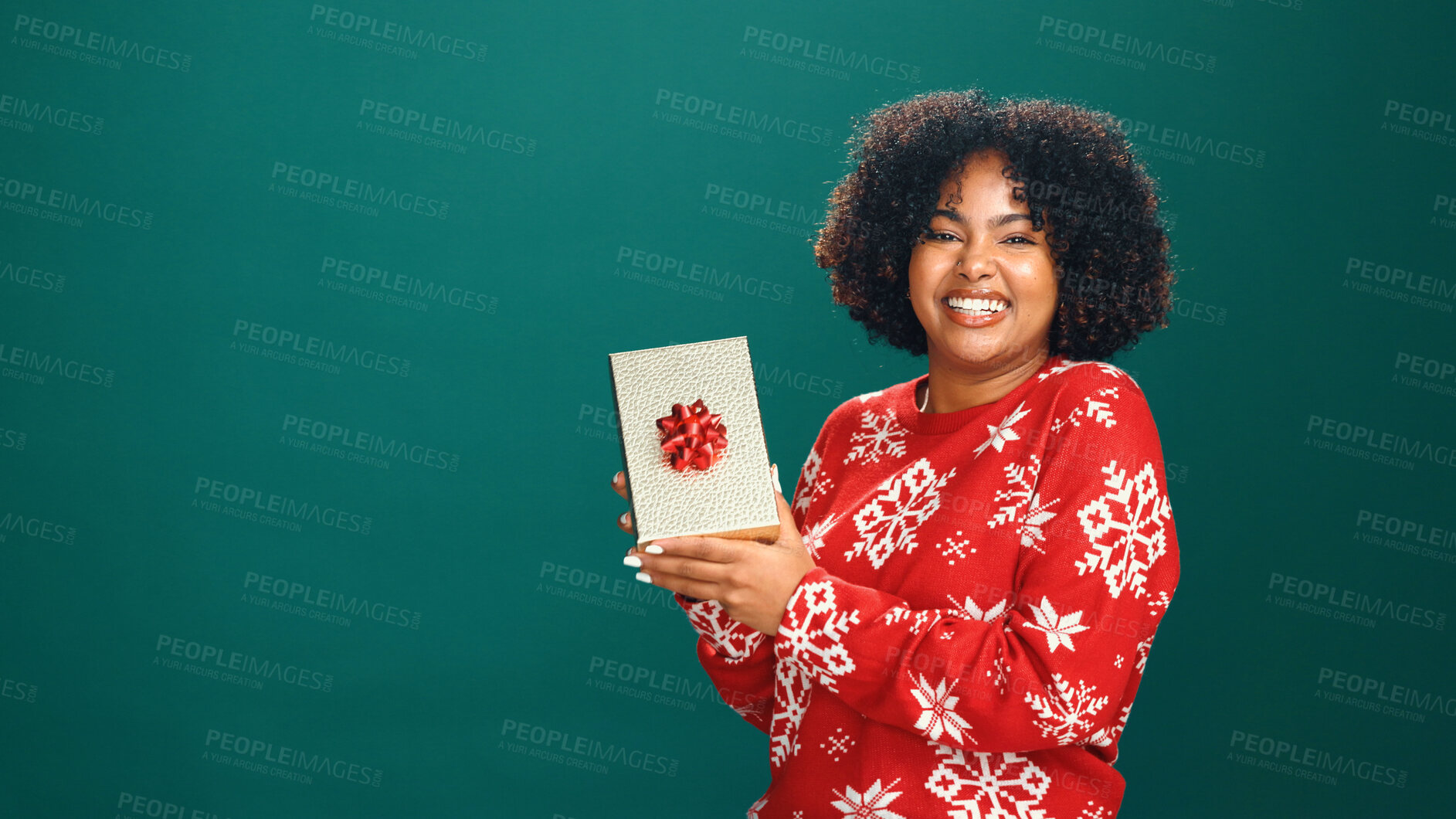 Buy stock photo Christmas present, portrait and black woman in studio for tradition, prize or giveaway on holiday. Excited, mockup space and African person with xmas gift for festive season by green background.