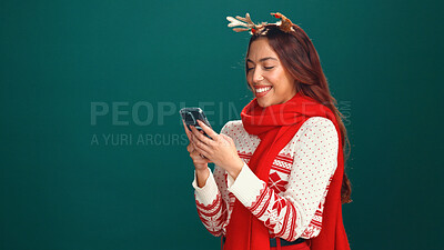 Buy stock photo Christmas, browsing and woman with smartphone, online shopping or planning for festive season on web. Green background, mockup space or person with xmas sweater, studio or mobile for holiday discount