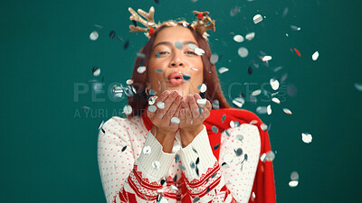 Buy stock photo Confetti, Christmas and portrait of woman in studio for party, festive season and holiday. Happy, December and person with decoration, glitter and blowing for xmas celebration on green background