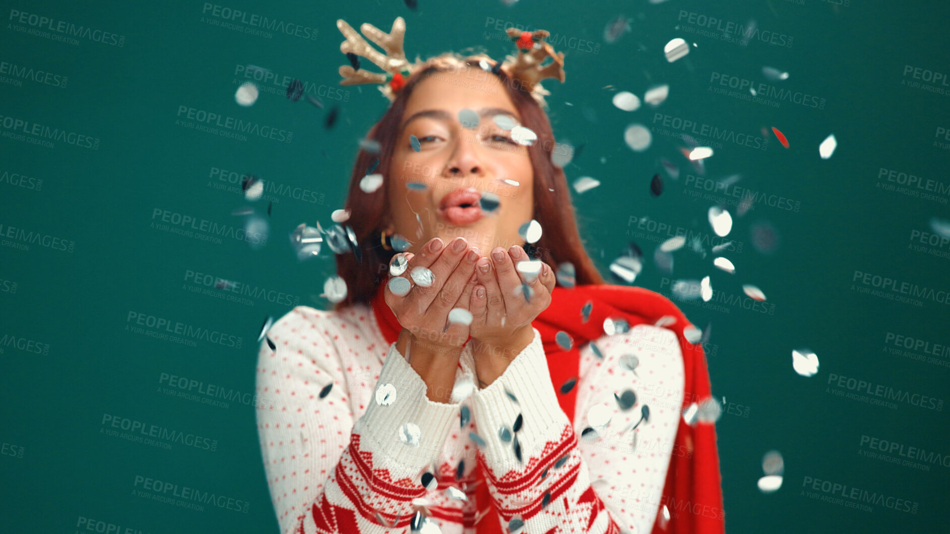 Buy stock photo Confetti, Christmas and portrait of woman in studio for party, festive season and holiday. Happy, December and person with decoration, glitter and blowing for xmas celebration on green background