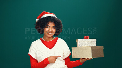 Buy stock photo Santa hat, portrait and black woman with gift in studio for Christmas tradition, festive or celebration. Happy, holiday and African female person with present box for xmas event by green background.