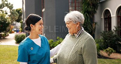 Buy stock photo Happy, outdoor and nurse with senior woman for fresh air, wellness and talking in nursing home. Retirement, conversation and caregiver with elderly person in garden for relaxing, support and helping
