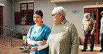 Holding hands, nurse and help with old woman outdoor for healthcare, occupational therapy and support. Kindness, rehabilitation and medical advice with person in nursing home for trust and caregiver