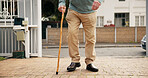 Legs, senior person and outdoor with walking stick for balance, steps and recovery in retirement. Elderly patient with disability, shoes and wooden cane with rehabilitation process for stroke