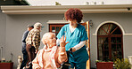 Nurse, old woman and talk outdoor with wheelchair, push and recovery with healing at retirement home. Caregiver, conversation and elderly person with disability, rehabilitation and injury in garden