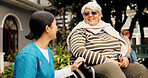 Nurse, old woman and smile outdoor with wheelchair, talk and listen with recovery at retirement home. Caregiver, happy and elderly person with disability, rehabilitation or injury with chat in garden