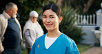 Happy, caregiver and portrait of woman outdoor with smile for fresh air, wellness or career at nursing home. Nature, backyard and confident person with pride for assisted living, senior care or nurse