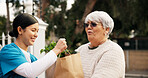 Nurse, senior woman and help with groceries, support and happy with volunteer services in retirement. Elderly person, caregiver and smile for package, assisted living and outdoor with shopping bag