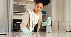 Cleaning, table and spray with woman in kitchen for washing, hygiene and bacteria prevent. Sanitary, safety and dirt with cleaner and liquid in home for soap, housekeeping and germ disinfectant