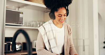 Buy stock photo Headphones, happy woman and listening to music in kitchen, podcast and sound. African person, smile and radio in home for streaming service with jazz, audio subscription and favorite song online