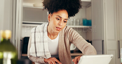 Buy stock photo Tablet, kitchen and woman in home for research, cooking guide and recipe tips online. African person, digital technology and reading blog on internet, lunch tutorial and website for information