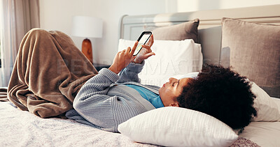 Buy stock photo Reading, relax and woman with phone on bed for social media, networking and online chat in home Happy, bedroom and African person on smartphone for internet, website and typing message on mobile app