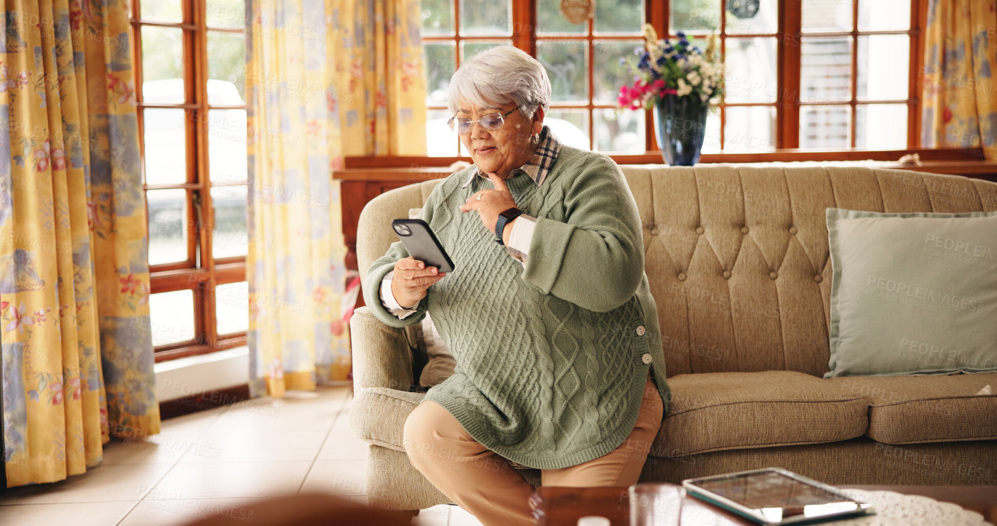 Buy stock photo Thinking, senior woman and phone at house for reading message, social media and feedback ideas. Elderly person, contemplating and mobile with online games, browsing website and solution for crossword