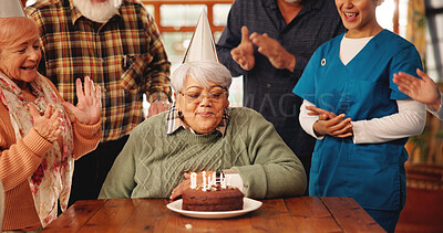 Buy stock photo Birthday cake, old people and blow candles in nursing home for celebration, clap or excited. Dessert, retirement group and friends at party, special event and congratulations with medical caregiver