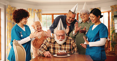 Buy stock photo Old people, nursing home and blow birthday cake with clapping, group celebration or happy. Candles, retirement party and senior friends at special event for congratulations with medical caregiver