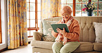 Streaming, movie and senior woman with tablet, living room or watching series on web or retirement . Happy, pensioner and elderly person with tech for entertainment, online or relax with film in home