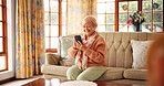 Senior woman, happy and phone on sofa for online bingo, playing word search or reading news. Retirement, relax and old person with smartphone in home for streaming service, internet games or browsing