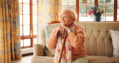 Buy stock photo Walking stick, happy and senior woman in home with nostalgia, retirement or remember memory. Relax, wood cane and elderly female person with a disability on sofa with daydreaming ideas in house.