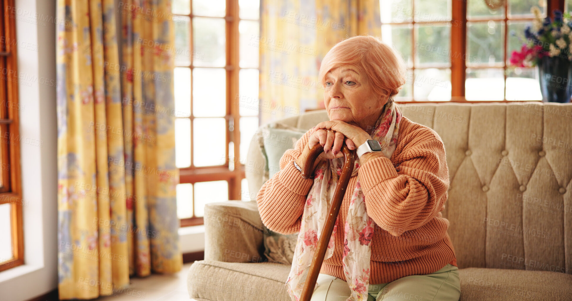 Buy stock photo Walking stick, memory and senior woman in home with thinking, retirement or remember nostalgia. Ideas, wood cane and elderly female person with a disability on sofa with daydreaming in house.