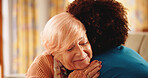 Nurse, senior woman and hug on sofa with smile, comfort and support in lounge at retirement home. People, caregiver and elderly person on couch, consultation or happy with embrace in living room