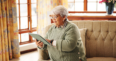 Buy stock photo Home, reading and old woman on sofa, tablet and website for online news report. Apartment, pensioner and elderly person on couch, technology and digital app for ebook, communication and email
