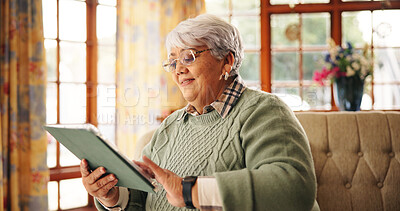 Buy stock photo Streaming, series and senior woman with tablet, living room or watching movie on web and retirement. Happy, pensioner and elderly person with tech for entertainment, online or relax with film in home