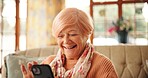 Senior woman, smile and phone on sofa for bingo game, playing word search or online news. Retirement, relax and old person with smartphone in home for streaming service, reading ebook or web browsing