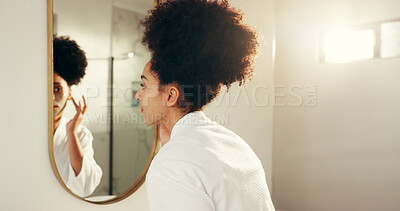 Buy stock photo Woman, mirror and skincare with facial cream for morning routine in bathroom, moisturizing and cosmetics. African person, reflection and daily skin care for dermatology, sunscreen and beauty in home