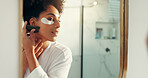 Woman, gua sha and skincare with eye patch for circulation, anti aging or facial healing in home. Mirror, person and bathroom with reflection for lymphatic drainage, dermatology or skin treatment