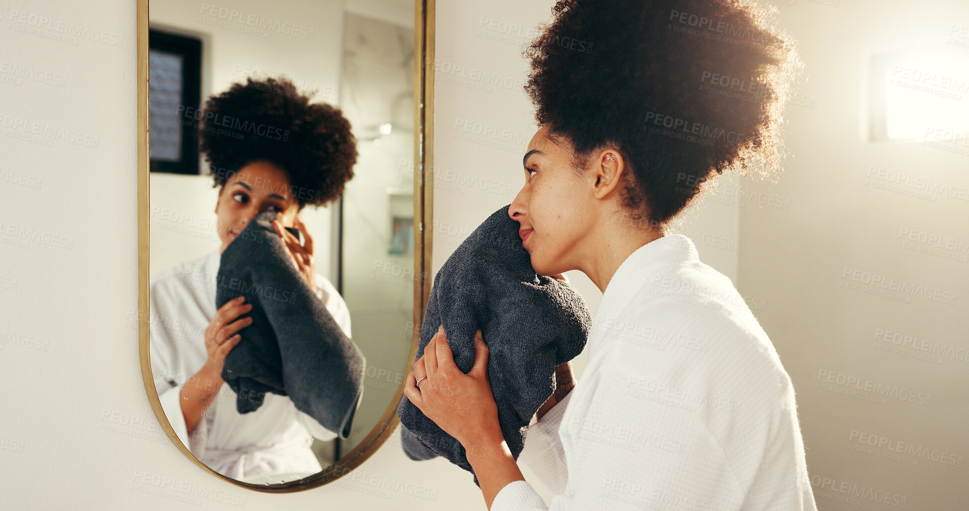 Buy stock photo Woman, mirror and skincare with towel for morning routine in bathroom, washing face or grooming. African female person, reflection and daily skin care for dermatology, wellness and beauty in home
