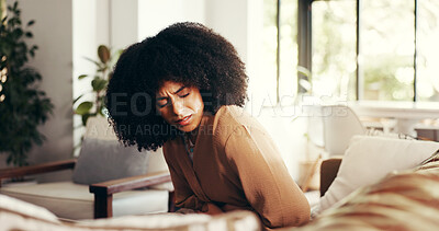 Buy stock photo Woman, stomach and cramps or pain on sofa for menstruation, ovarian cysts and discomfort in lounge. Girl, home and abdominal ache for monthly cycle, period and tension or strain in house living room
