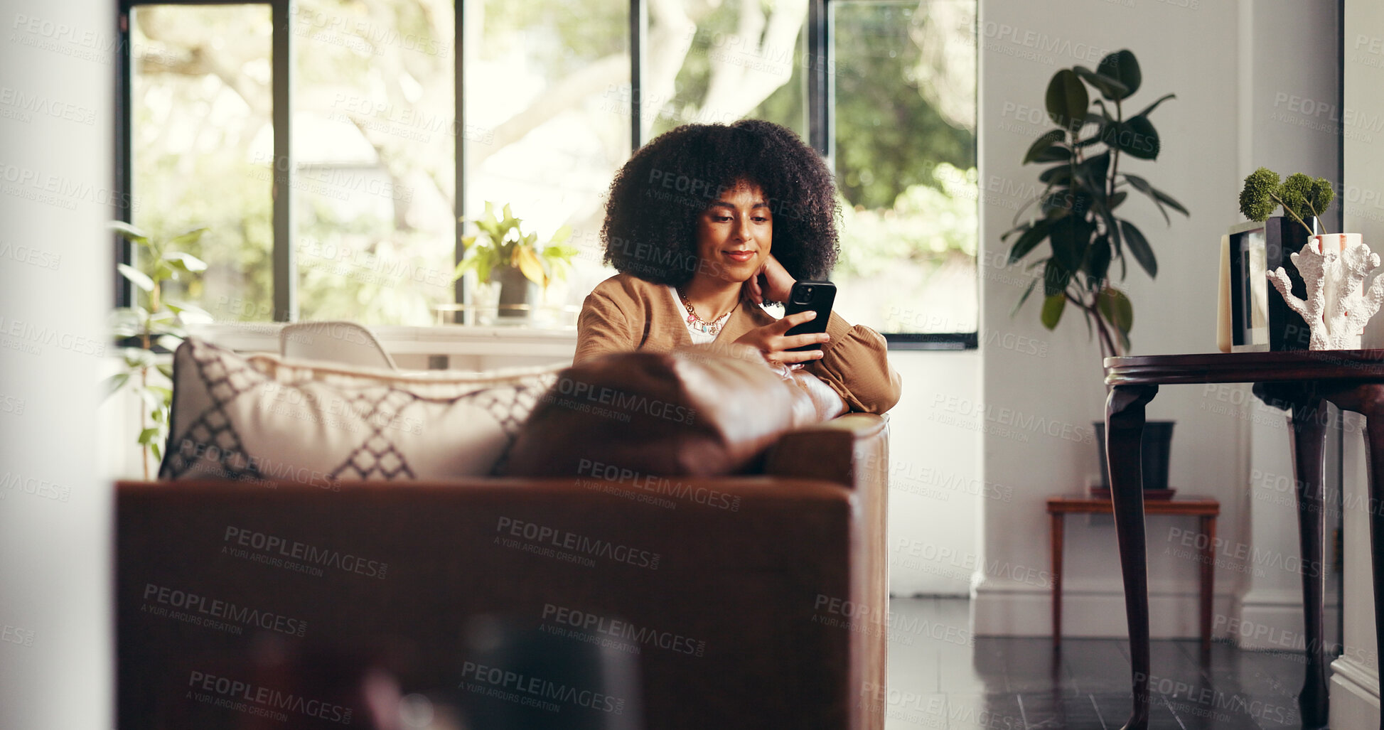 Buy stock photo Relax, woman and scroll with phone in home for reading news, app download or social media browsing. Smile, African person and smartphone in lounge for watching internet videos and online shopping