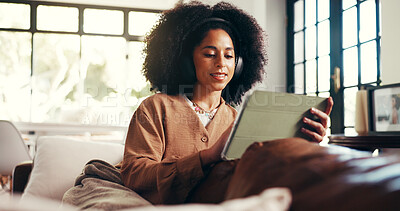 Buy stock photo Headphones, woman or scroll with tablet on sofa for music search, streaming podcast or online show. Cozy, african person or relax with digital app in home with sound playlist, movie and weekend break