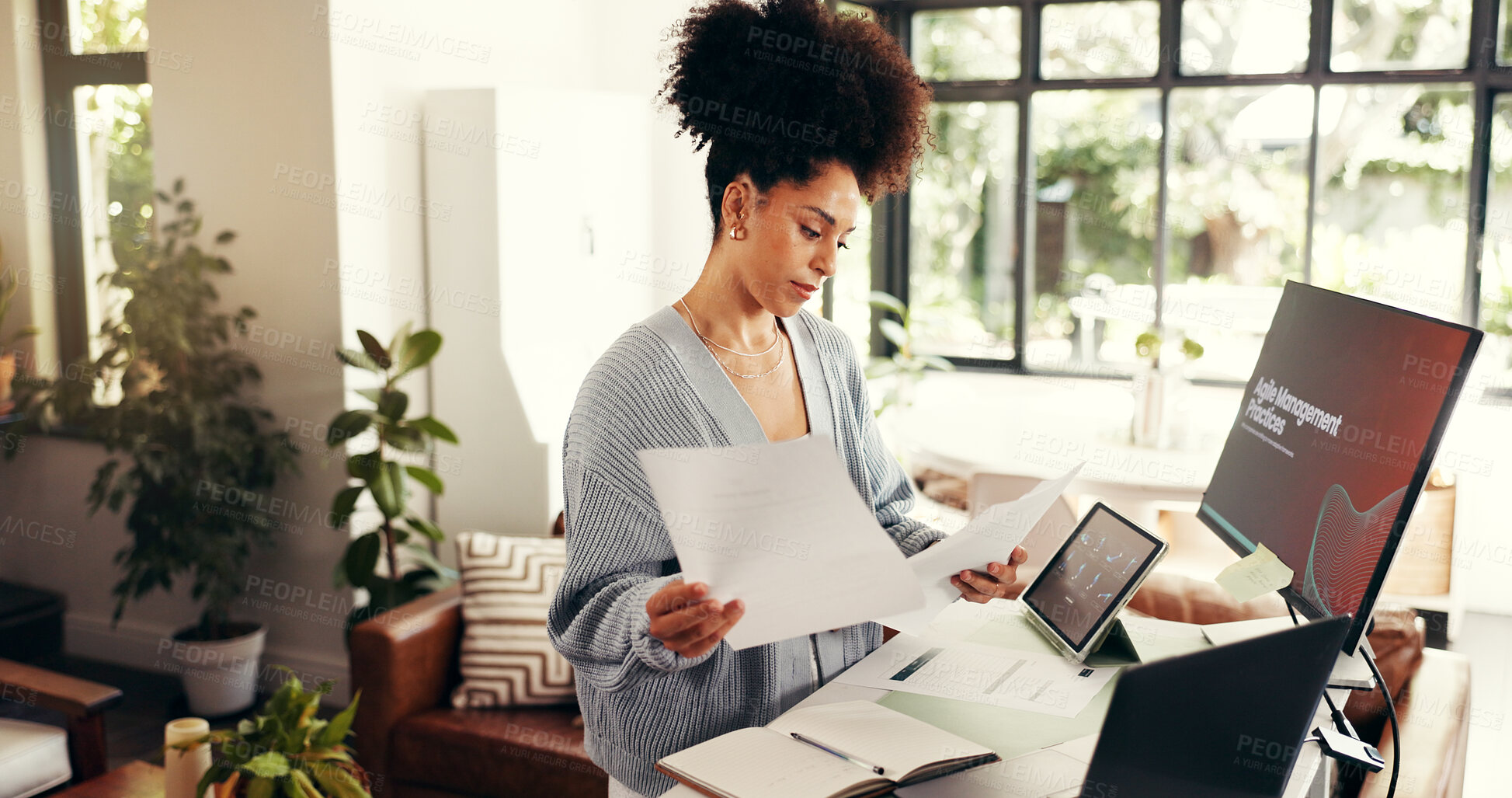 Buy stock photo Remote work, paperwork and african woman with technology and analysis in home office. Online, research and person reading document for agile management, planning and freelance project at house