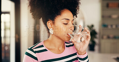 Buy stock photo Woman, drinking water and glass in kitchen, home and hydration for wellness, detox and start morning. African person, liquid and aqua for digestion, gut health and natural beverage at apartment
