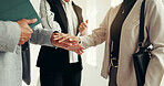 Business people, meeting and hands together in huddle for teamwork, unity or trust in office. Group, employees or touch with pile, stack or deal in solidarity for mission, collaboration or agreement