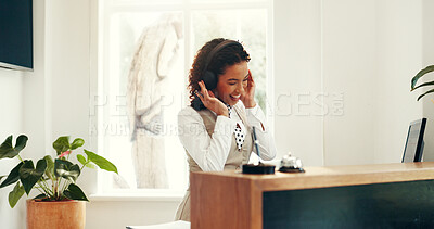 Buy stock photo Headphones, woman and hotel receptionist with music, playlist or online radio on break. Happy, audio tech and female concierge listening to album for entertainment at front desk at accommodation.
