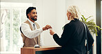 Man, keys and hotel lobby for businesswoman, welcome or registration for accommodation. People, check in and happy at concierge, mature client or help desk with hospitality for suite booking at lodge