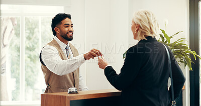 Buy stock photo Man, keys and hotel lobby for businesswoman, welcome or registration for accommodation. People, check in and happy at concierge, mature client or help desk with hospitality for suite booking at lodge