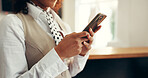 Hotel, receptionist and hands with smartphone, research or checking reservation on web and schedule. Motel, concierge and person with mobile for booking info, update and browsing for request on app