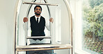 Porter, luggage and push trolley in hotel for suitcase handling, check in welcome or guest arrival. Hallway, hospitality and man with cart at luxury resort for bellboy assistance, concierge and help