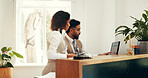 Hotel, receptionist and colleagues with computer, research and collaboration for reservation on web. Online, man and woman with tech for registration info, teamwork and planning for schedule in motel