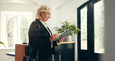Buy stock photo Business, woman and tablet at hotel reception for check in, reservation and booking confirmation. Mature person, digital and travel website, review schedule and information for hospitality enquiries