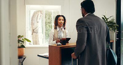Buy stock photo Hotel, tablet and concierge with man at front desk for reservation, booking room and check in. Hospitality, lobby and receptionist with client on tech for help, online service and accommodation info