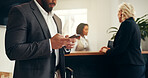 Businessman, hotel and waiting with phone for check in, accommodation or online booking in resort. Man, hands and typing with mobile smartphone for luggage, stay or hospitality at front desk service