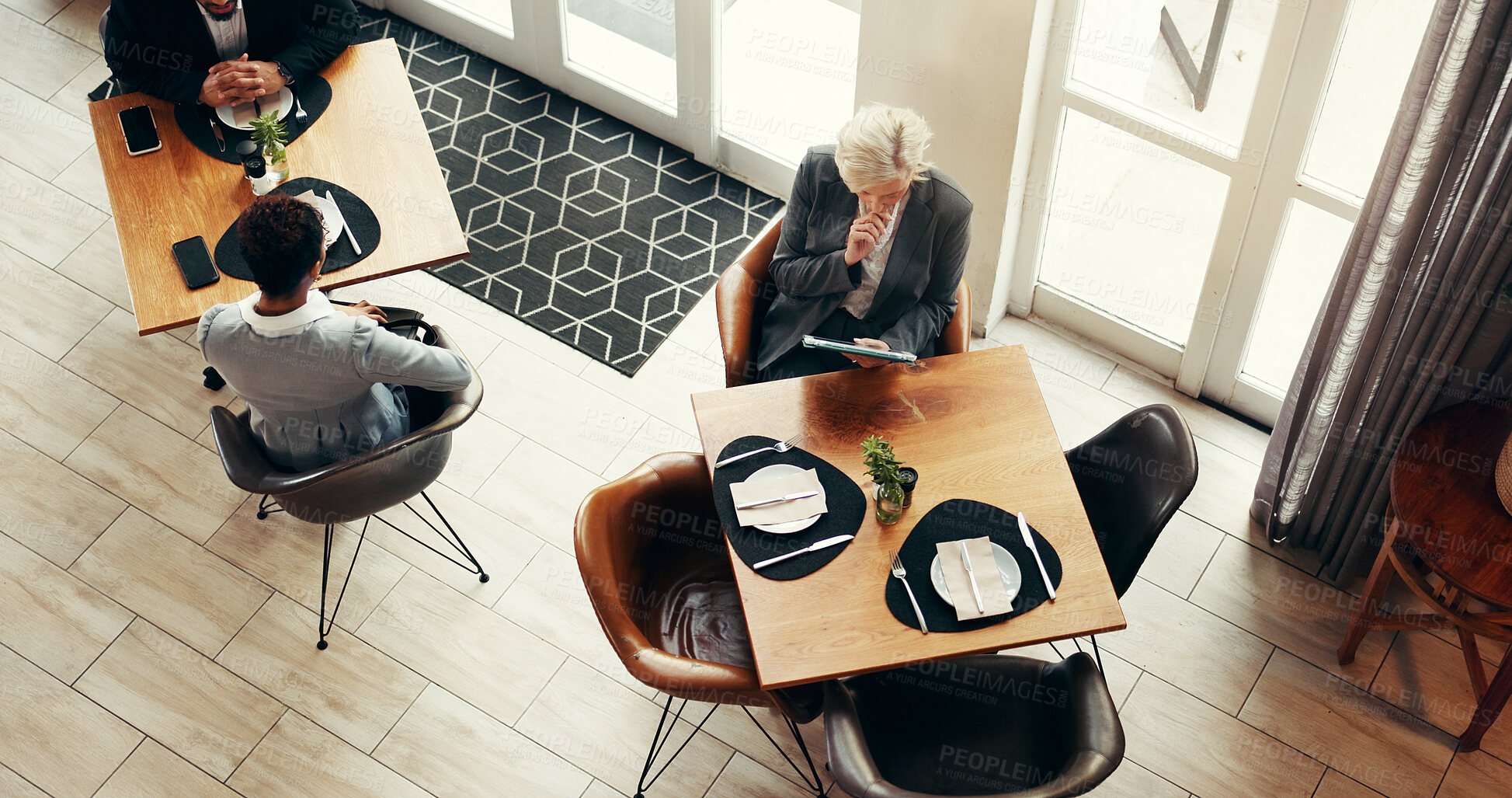 Buy stock photo Mature business woman, tablet and coffee shop for remote work, reading and above for review at diner. Person, tech and check notification with application, scroll and contact on web at cafeteria